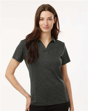 A woman modeling a dark heather gray short-sleeve polo shirt against a clean, light off-white background.
