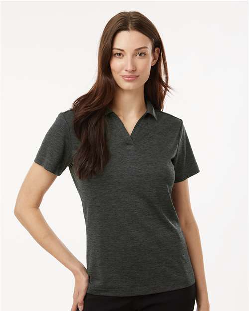 A woman modeling a dark heather gray short-sleeve polo shirt against a clean, light off-white background.